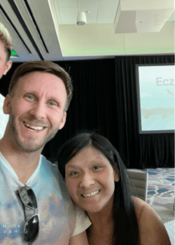 photo of a couple waving and smiling at the camera