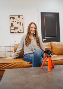 Photo of a woman smiling on a couch