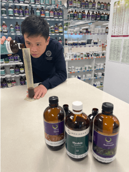 Ben puts medicine in a long tube.